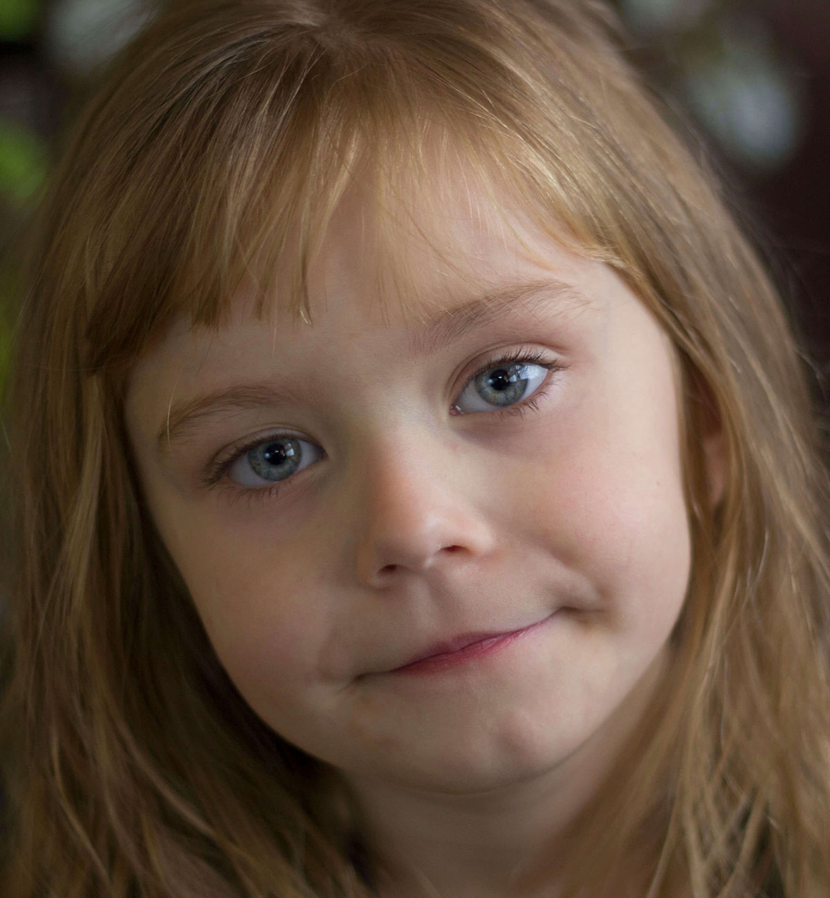 Close-up child portrait indoors with soft window light